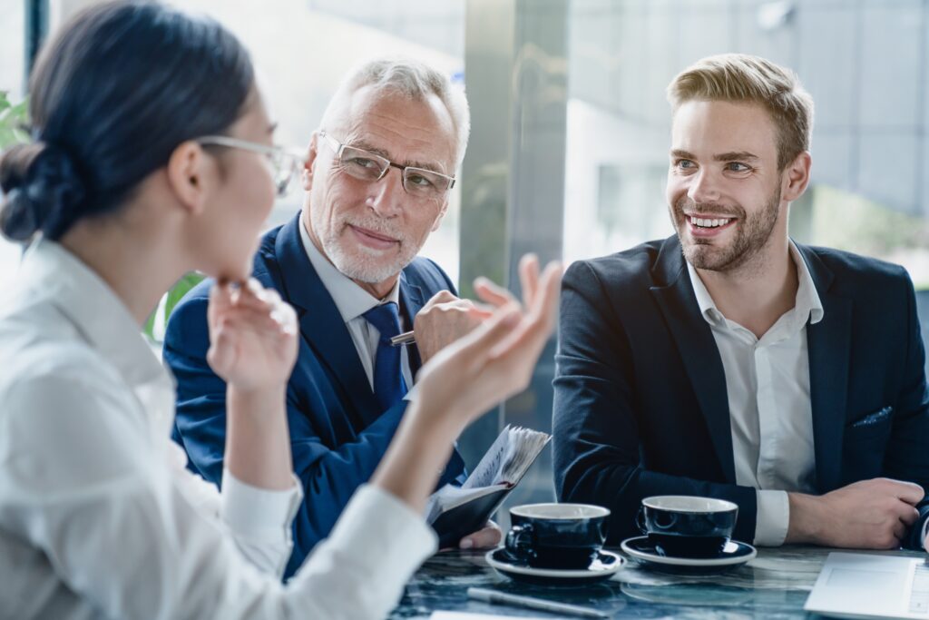 Two business owners talking to a business development consultant