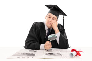 A new grad holding a magnifying glass searching for an entry-level job.